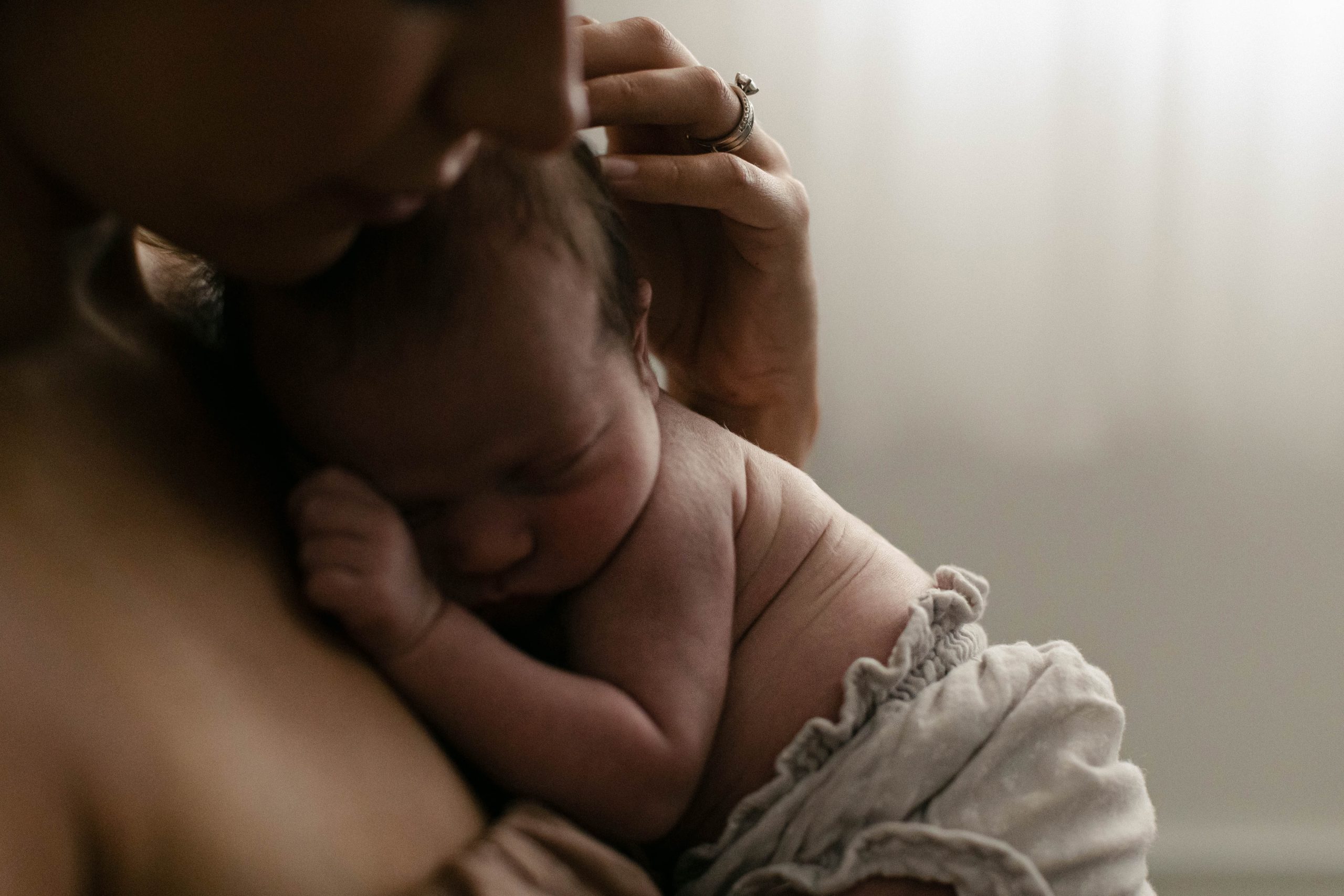 mom snuggling newborn during a photo session