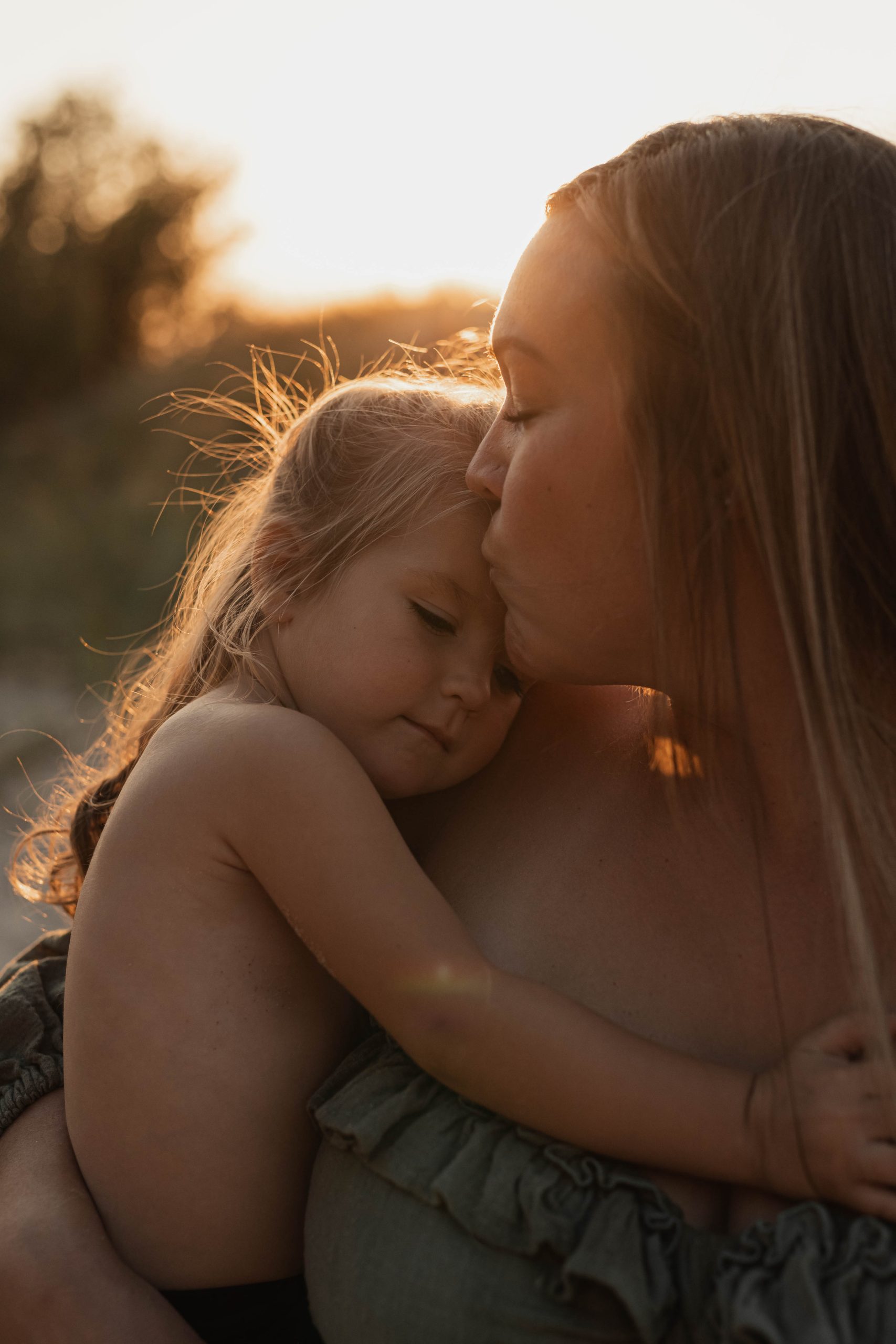 special moment between mom and daughter. sunset photoshoot at lake michigan