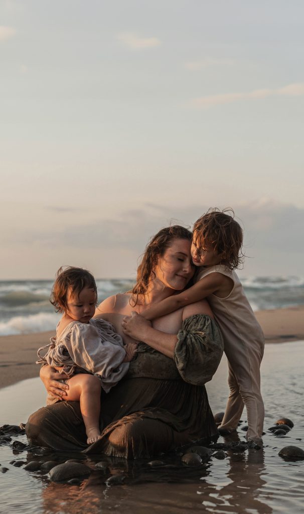 Beautiful quiet moment with mom and kids during lake michigan beach session with alissa saylor