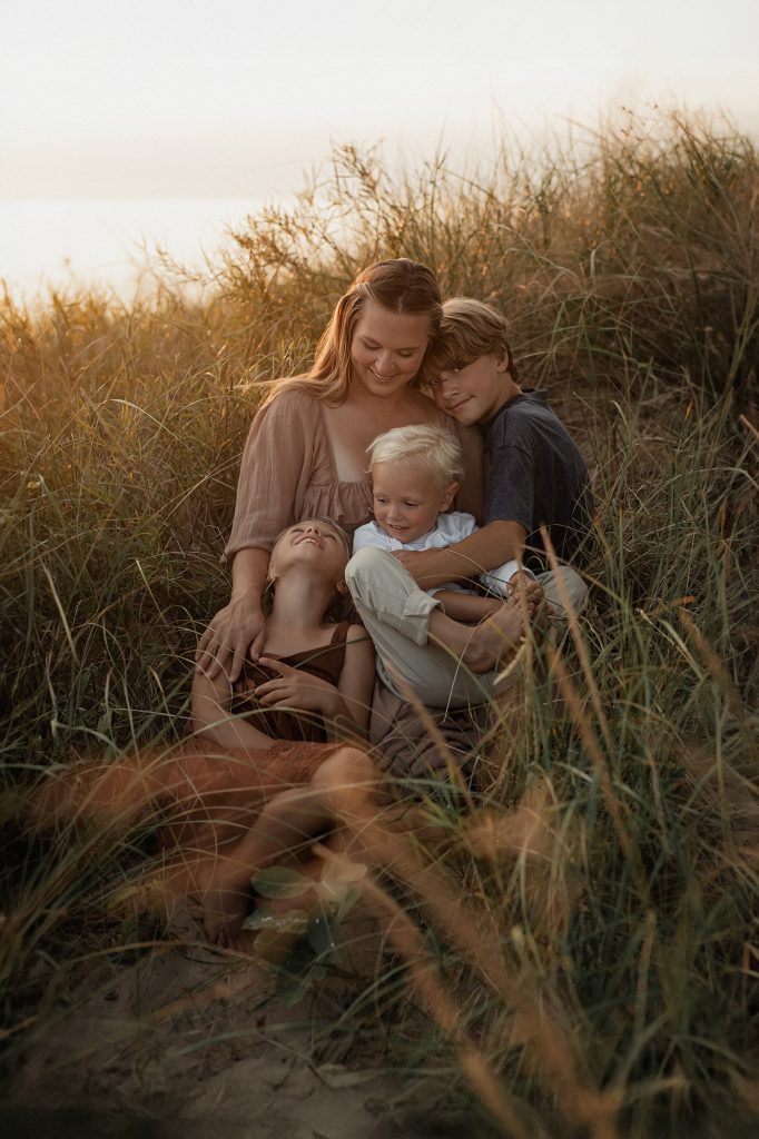 mom with her children in the lake michigan dunes