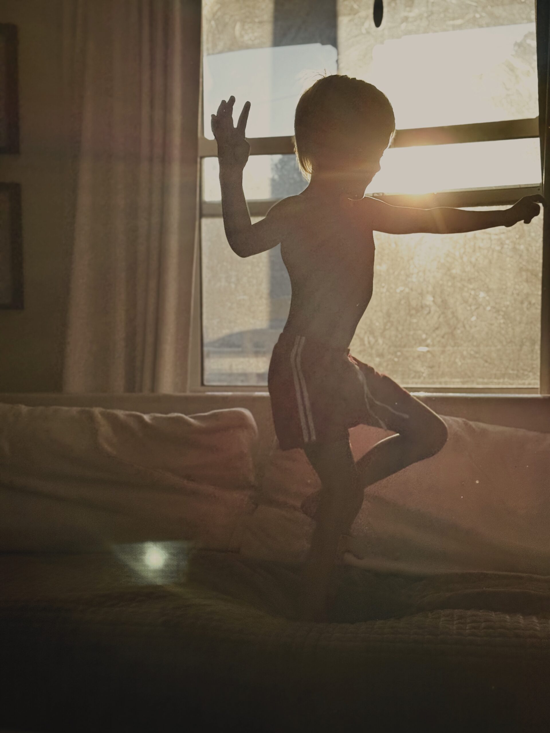 photograph of a young boy that wont sit still in golden light