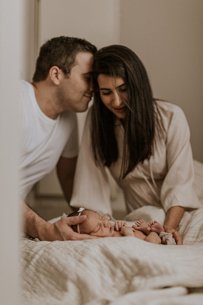 mom and dad with newborn during in-home newborn session with Alissa Saylor
