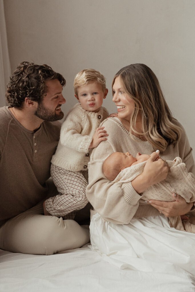 family dressed in casual neutrals for a West Michigan studio newborn session with Alissa Saylor